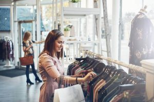 Female customer is choosing clothes in the store